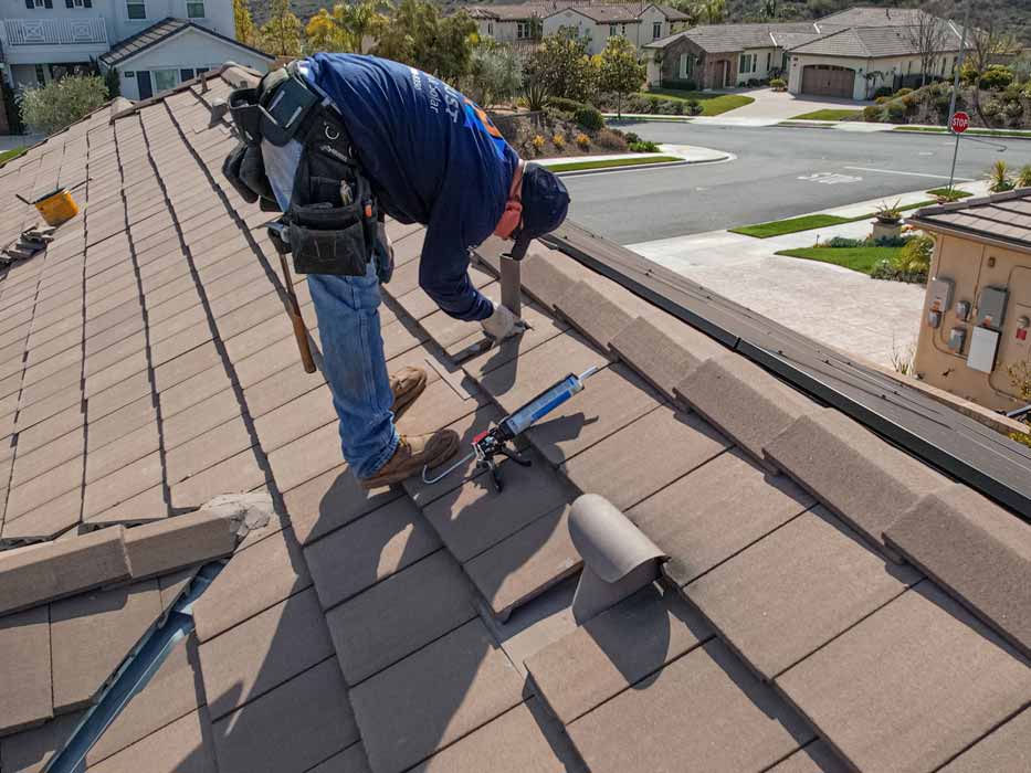 Team member installing roof tiles